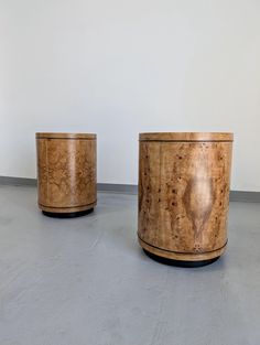 two wooden containers sitting next to each other on top of a cement flooring area