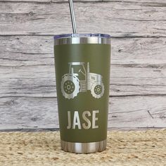 a green tumbler with a tractor on it and the word jase written in white