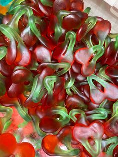 some red and green gummy bears in a bowl