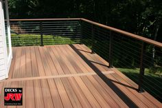 a wooden deck with metal rails and railings