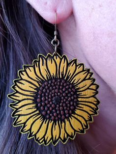 Wooden sunflower earrings handpainted and sealed to preserve color. Antique brass ear wire. Length of earring: 2 inches Width of earring: 2 inches Hand Painted Yellow Earrings For Summer, Yellow Sunflower Design Earrings As Gift, Yellow Sunflower Design Flower Earrings As Gift, Yellow Sunflower Design Earrings For Summer, Yellow Hand Painted Artsy Earrings, Yellow Sunflower Design Earrings Gift, Summer Sunflower Dangle Earrings, Yellow Sunflower Design Dangle Earrings, Yellow Flower Shaped Jewelry With Sunflower Print