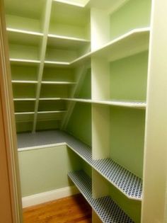 an empty walk in closet with lots of shelves