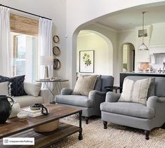 a living room filled with furniture and windows