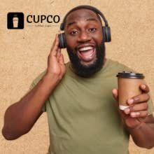 a man with headphones on holding a coffee cup