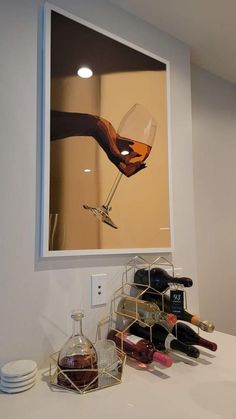 a wine glass is being held up by someone's hand in front of a mirror