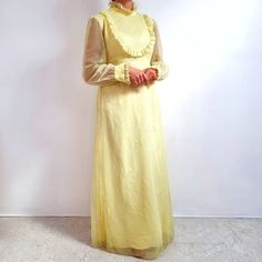 Stunning 60's maxi dress in yellow. It has a frilly neckline and chest, long sheer sleeves with frilly ends, fitted waist with long ties, zip at the back and a-line skirt part. It is made from a lightweight, sheer fabric with tiny dot pattern and lined with yellow viscose fabric lining. A true, rare vintage dress, perfect for special occasions. Made by Ladies Garment Workers Union in U.S.A. 100% polyester,  100% viscose lining. Labelled as size 16, would fit Medium size. Measurements when laid f 60s Maxi Dress, Workers Union, Garment Workers, Yellow Maxi Dress, Yellow Maxi, 60s Mod, 60s Vintage, Sheer Fabric, Dress Medium