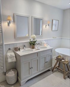 a bathroom with two sinks and a bathtub