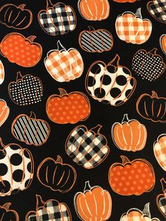 an orange and black pattern with pumpkins on it