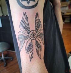 a man with a tattoo on his arm and an all seeing eye in the middle