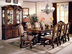 a dining room table with chairs and a china cabinet