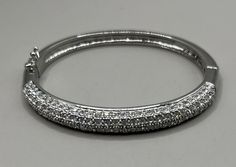 "Featuring the sparkly clear rhinestone bangle bracelet. It has a silver tone setting and measures 2 1/4\" diameter. The bracelet will fit a smaller to average wrist, and it is in very good vintage condition. The bracelet opens and has a safety latch on it." Silver Mask, Sparkly Bracelets, Dichroic Pendant, Faux Stone, Silver Bangle Bracelets, Bead Charm Bracelet, Rhinestone Bracelet, Bracelet Silver, Metal Bracelets