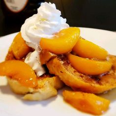 a white plate topped with bananas and whipped cream