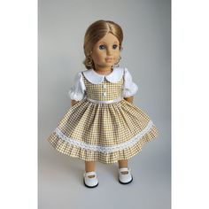 a doll is wearing a dress and shoes