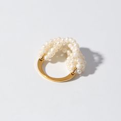 Experience the charm of our handcrafted Woven Multi-Layer Freshwater Pearl Ring. Its intricate woven design showcases expert craftsmanship and timeless elegance. Each natural pearl adds a unique luster and texture to the ring, while the multi-layered weave creates depth and sophistication. Metal: 18K Recycled Gold Plated On Brass Gemstone: Freshwater Pearl Ring Sizes Available: US 6, 7, 8 Real Pearl Jewellery, Pearl Cluster Ring, Woven Ring, Freshwater Pearl Ring, Rice Grain, Pearl Cluster, Gold Choker Necklace, Pearl Set, Woven Design