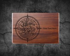 a wooden plaque with an image of a compass and the words your text here on it