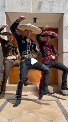 three men wearing sombreros are posing for the camera