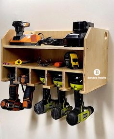 a wooden shelf filled with lots of different types of power drillers and other tools