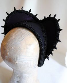 This is a purple and black version of one of most successful designs called Countess. This vampire style headdress is covered with dark purple taffeta and embellished with black cord trimming all around the edges.It is further trimmed with black crystal details that create a halo effect as well as small l beads that were hand-sewn on the trimming to create rich textural interest. The piece is completed with a black crystal handmade element placed at the center front for all that extra drama that Black Medieval Costume Accessories For Cosplay, Medieval Black Costume Accessories For Cosplay, Gothic Costume Hats For Masquerade And Carnival, Gothic Costume Hats And Headpieces For Masquerade Carnival, Gothic Adjustable Costume Accessories For Carnival, Adjustable Gothic Costume Accessories For Carnival, Black Steampunk Costume Accessories For Cosplay, Steampunk Black Costume Accessories For Cosplay, Black Fitted Fantasy Costume Hats And Headpieces