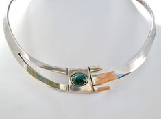 Mexican Jewelry - This is a sterling silver collar necklace with a green malachite gemstone. It is hallmarked 925 Mexico with additional marks, .75" wide, gem is 10mm by 8mm, inside circumference is 11.75", opening is 3..25", weight is 45 grams. Modern Green Necklace With Polished Finish, Modern Green Cabochon Jewelry, Formal Malachite Jewelry With Polished Finish, Elegant Silver Malachite Jewelry, Modern Green Malachite Jewelry, Modernist Green Jewelry For Gifts, Green Oval Modernist Jewelry, Green Modernist Oval Jewelry, Silver Round Malachite Jewelry