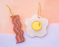 These light-weight bacon and eggs earrings are the perfect statement earrings to add an extra pop to your outfit! Acrylic is very lightweight so you can enjoy large, statement earrings comfortably all day. ♡ Made with white pearl acrylic and glitter acrylic that doesn't flake! ♡ Size:    - Bacon: Approximately 2.5 inches in length measured from earring hoop   - Egg: Approximately 2.25 inches in length measured from earring hoop ♡ Earring hoop is 18k gold plated brass ♡ Care Instructions: ♡ - To Acrylic Charm Earrings, Pearl Earring Jacket, Earrings Funny, Funny Jewelry, Bacon And Eggs, Large Statement Earrings, Earring Hoop, Silver Diamond Earrings, Bridal Wedding Earrings