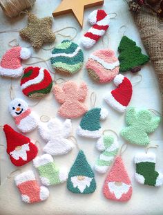 knitted christmas ornaments are displayed on a table