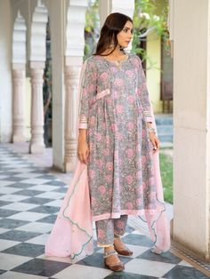 A poetic rendetion of a summer festive collection that makes you nostalgic, in classic luminous block prints. Handcrafted on a bed of fine cotton, mul and doria in hues of pastels. Perfect for light occasions. A set of 3 consists of kurta, pants & dupatta. Kurta: Summery florals combined with the most delicate silhouette inspired by the vintage bhopali grey kurta. This round neck, side gathered ghera kurta in cotton with loop button and gota detailing is a summer staple . Finished with hand prin Diwali Cotton Silk Kurta With Floral Print, Diwali Cotton Silk Floral Print Kurta, Diwali Floral Cotton Silk Kurta, Anarkali Palazzo Set In Floral Cotton Silk, Anarkali Style Floral Cotton Silk Palazzo Set, Designer Cotton Kurta With Floral Print, Bohemian Chanderi Palazzo Set With Floral Print, Traditional Drape Cotton Silk Sets With Floral Print, Bollywood Cotton Silk Sets With Floral Print