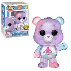 a purple and blue teddy bear with stars on it's chest, next to a box