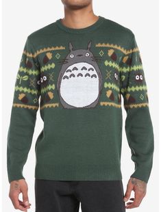 a man wearing a green sweater with totoro on it