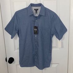 Never Been Worn, Still Has Tags! Washed Blue Slim Fit Button-up Tops, Blue Relaxed Fit Button-up Short Sleeve Shirt, Denim Blue Button-up Top With Snap Buttons, Blue Button-up Short Sleeve Shirt With Button Closure, Indigo Button-up Shirt With Pockets, Plaid Shorts, Mens Vans, Slim Fit Shirt, Travel Shirts