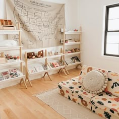 a living room filled with furniture and bookshelves next to a large map on the wall