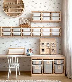 a wooden shelf filled with plastic containers next to a white chair and wall mounted clock