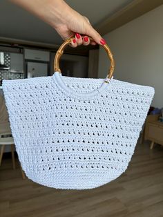 Introducing the perfect accessory for summer outings - a crochet white summer bag with a stylish wooden handle! This beautiful bag is handmade with care and is the ideal blend of fashion and functionality. The white crochet design adds a touch of elegance, while the sturdy wooden handle ensures durability and ease of carrying. Whether you're heading to the beach, a picnic, or a day of shopping, this bag is sure to be your go-to accessory. Stay chic and organized with this lovely crochet summer b White Bags With Bamboo Handle For Everyday Use, White Tote Bag With Bamboo Handle, Rectangular White Crochet Bag For Vacation, White Straw Bag With Bamboo Handle, White Rectangular Straw Bag With Bamboo Handle, White Rectangular Crochet Bag For Beach, White Summer Bags With Bamboo Handle, White Crochet Bag For Spring Vacation, White Rectangular Crochet Bag For Beach Season