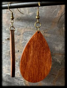 Whimsical Pumpkin Earrings are made of wood and engraved with a swirled pumpkin design. These are stained with two colors to blend together the perfect autumn color. The earrings dangle with antique bronze hypoallergenic hooks and are extremely lightweight. - Wooden Earring is 1.8 inches long (not including hook and jump rings). - Each pair will be made as shown in the example and sealed (stained wood grain could vary slightly with each pair) Teardrop Wooden Earrings For Gifts, Teardrop Wood Earrings For Gifts, Wooden Teardrop Earrings As Gift, Wooden Teardrop Earrings For Gift, Rustic Brown Teardrop Jewelry, Artisan Brown Wooden Earrings, Artisan Brown Wood Earrings, Handmade Teardrop Natural Wood Jewelry, Handmade Natural Wood Teardrop Jewelry