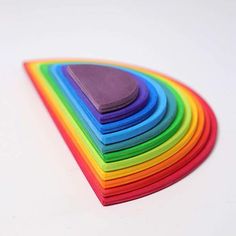 a stack of multicolored paper sitting on top of a white table next to each other