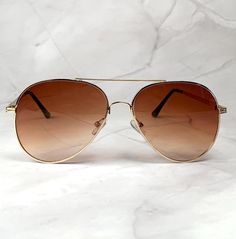 Introducing our Classic 70s Brown Aviators with gold metal and brown plastic frame-- a timeless fusion of vintage charm and contemporary style. Elevate your eyewear collection with these distinctive pilot shades that seamlessly blend classic design elements with a modern twist. Embrace a bold and distinctive look with the octagonal frame, reminiscent of the iconic 70s aviator style.  Stand out from the crowd with a shape that exudes confidence and individuality. Order yours now and experience th Luxury Vintage Brown Aviator Sunglasses, Luxury Brown Vintage Aviator Sunglasses, Men Aviator Sunglasses, Birthday Sunglasses, Aviator Sunglasses Mens, Aviator Style, Birthday Gift For Him, Aviator Sunglasses, Eyewear Sunglasses