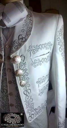 a white jacket with silver buttons on it