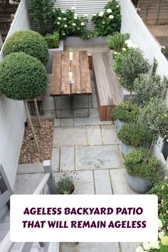 an aerial view of a backyard patio with wooden table and benches surrounded by potted plants