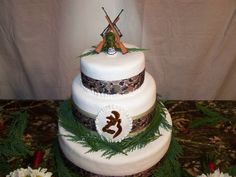 a three tiered cake decorated with flowers and grass