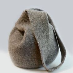 a gray bag sitting on top of a white table