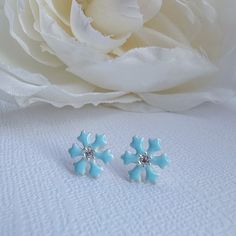 Beautiful and dainty pair of snowflake stud earrings in baby blue with shiny Cubic Zirconia in 925 high quality sterling silver. Earrings are perfect for any age. Metal : 925 Sterling Silver. ( 925 stamped ) Measurements : 8mm x 8mm. Gemstone: Cubic Zirconia. These delicate stud earrings are handcrafted from 925 sterling silver, that doesn't tarnish their little ears, hypoallergenic, nickel and lead free. ADD TO YOUR ORDER: 925 Sterling silver butterfly silicone coated backings link:  https://ww Light Blue Flower Shaped Jewelry Gift, Light Blue Flower-shaped Jewelry For Gifts, Cute Silver Flower Shaped Earrings, Blue Earrings For Christmas Gift, Cute Hypoallergenic Silver Flower Earrings, Cute Silver Flower Earrings For Gift, Cute Silver Flower Earrings As Gift, Light Blue Flower Shaped Earrings For Gift, Cute Light Blue Earrings Gift