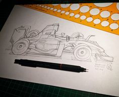 a pencil drawing of a race car on top of a piece of paper next to a ruler