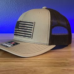 Duck Camo American Flag Patriotic Hunting Leather Patch Hat Khaki/Brown. Specifications: 🧢 Richardson original 112 trucker; adjustable for the perfect fit 🎩 60/40 cotton/polyester blend for comfort 📏 One size fits most 🏷️ Expertly laser engraved leatherette patch design 📦 Ships in 2 to 3 business days from our Orlando Studio Care Instructions: 🚫 Do not wash; spot clean only Please Note: 🌈 Colors may vary from photos based on your viewing screen. Brown Military Hat With Curved Brim, Brown Military Trucker Hat, Military Style Brown Hat With Curved Brim, Brown Military Style Trucker Hat, Brown Military Visor Hat, Brown Military Hat, One Size Fits Most, Brown Military Hat For Outdoor, Military Style Brown Baseball Cap, Adjustable Brown Trucker Hat For Sports