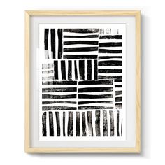 a black and white abstract painting in a wooden frame on the wall above it is a framed