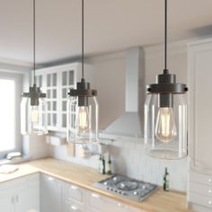 three lights hanging from the ceiling in a kitchen