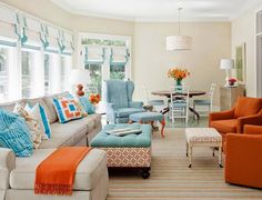 a living room filled with lots of furniture and decor on top of a hard wood floor