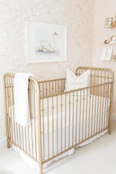 a baby's crib in a pink and white nursery