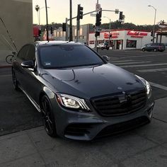 a mercedes s - class is parked on the side of the road