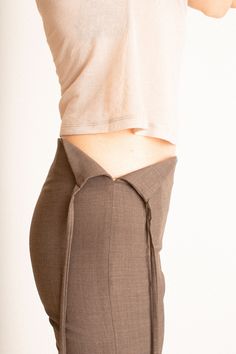 90's style low rise pant with tie at the side. Wear tied or open. Fabric is 53% recycled polyester 25% mulesing free wool, 20% European flax linen, and 2% elastane. Ella is 6' tall, 35" bust, 26" waist, 36" hip, and is wearing a size 36. Low Back Knit Top, Felted Clothing, Fitted Brown Cotton Pants, Low Waist Linen Pants, Low Rise Knit Pants, Vintage Fitted Pants With Button Closure, Paloma Wool Pants Skirt, Paloma Wool Pants, Low Waist Pants