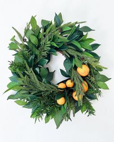 a wreath with oranges and green leaves