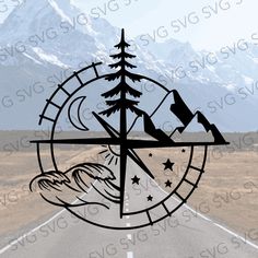 an image of a compass with mountains in the background